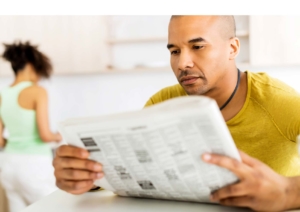 Man reading newspaper | Churchill Forge Properties